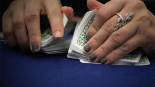 Dealer shuffling cards